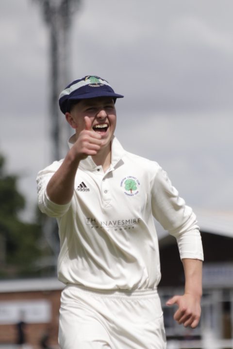 Cricket player smiling, putting thumb up to the camera